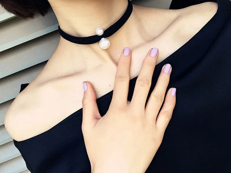 Hand-woven yarn necklace in black with simple college style on a white surface