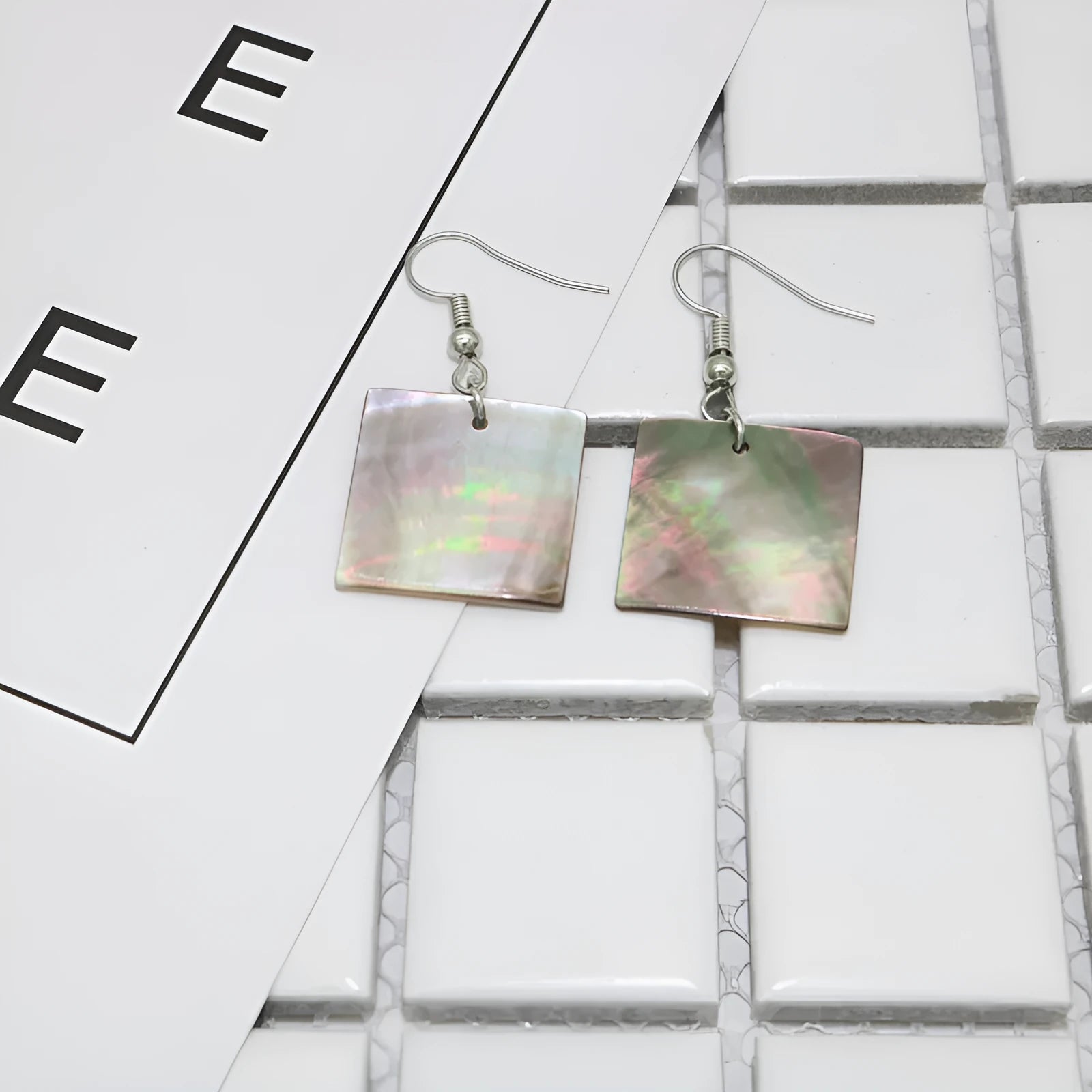 Women's geometric shell earrings with rectangular or square panther designs in natural colours