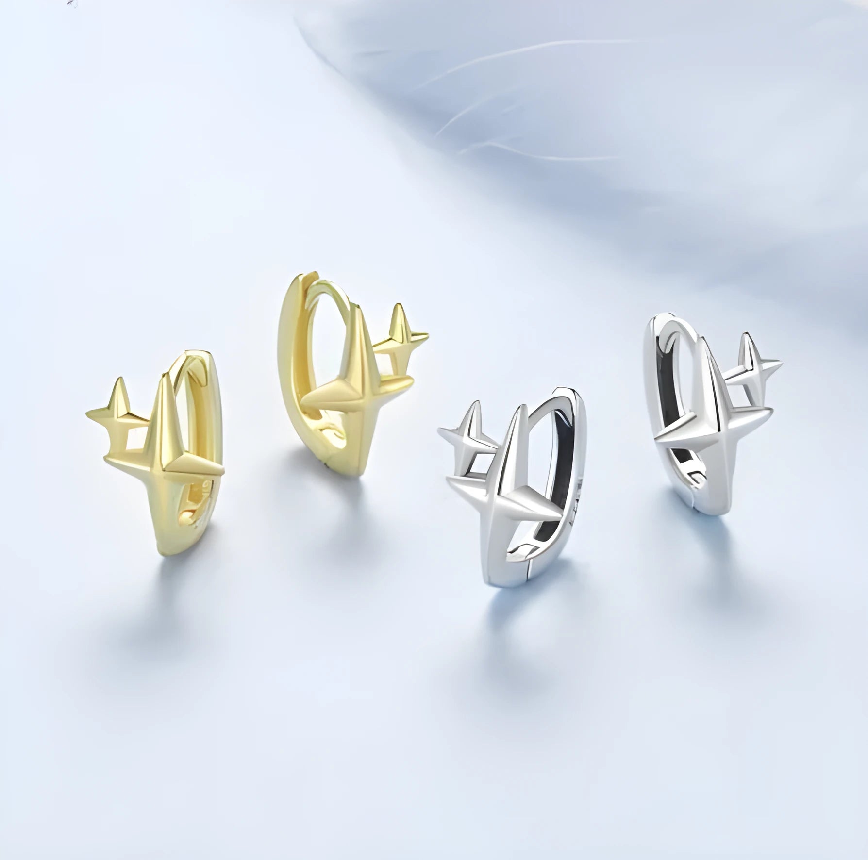 Minimalist oxidised sterling silver ear clips with geometric star designs