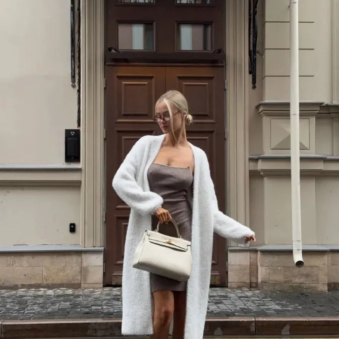 White loose-fit longline cardigan jacket with long sleeves, made of thick knitted polyester fabric.