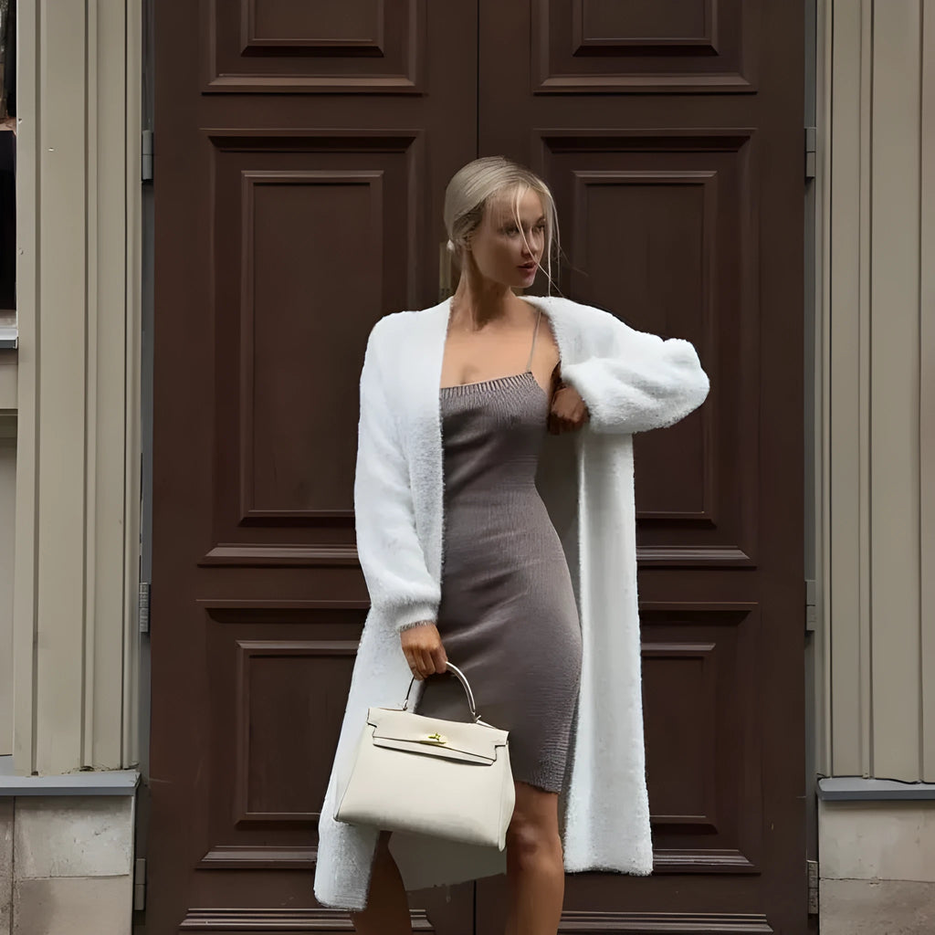 White loose-fit longline cardigan jacket with long sleeves, made of thick knitted polyester fabric.