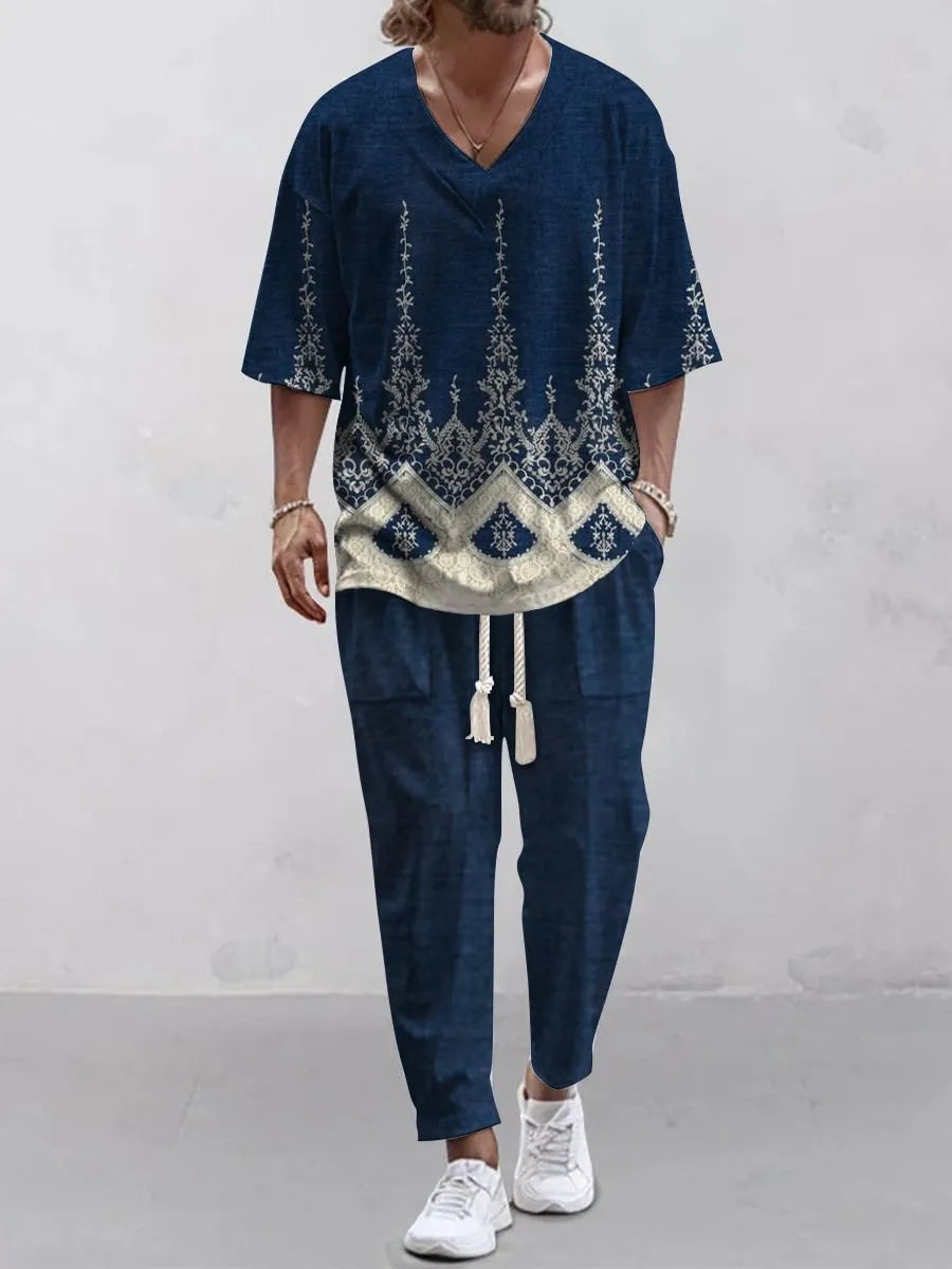 Thin polyester trousers suit with V-neck cropped sleeve jacket and matching trousers on a hanger.