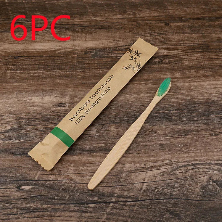 Set of ten bamboo toothbrushes with charcoal-infused bristles in assorted colours on a white background.