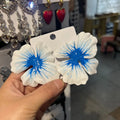A pair of pastoral style alloy stud earrings with oil-spot glaze floral design in one of four colours.