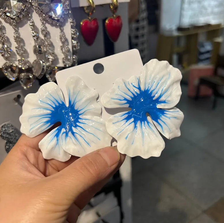 A pair of pastoral style alloy stud earrings with oil-spot glaze floral design in one of four colours.