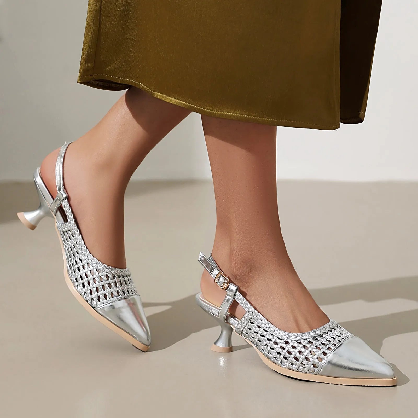 Gold women's sandals with a cat heel, buckle strap, and rubber sole.