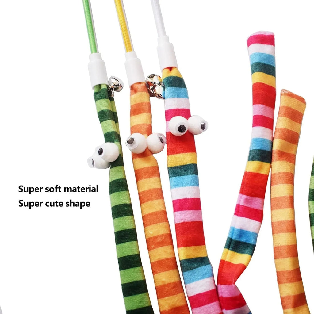 Colourful cat teaser wand with a long plush strip and a bell, held by a person.
