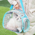 Transparent hard-sided cat carrier backpack in lake blue colour showing interior space and backpack straps