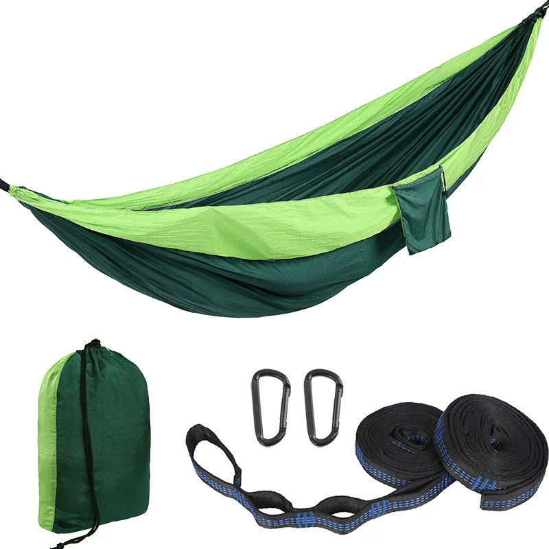 Double camping hammock with ropes and buckles shown in outdoor setting