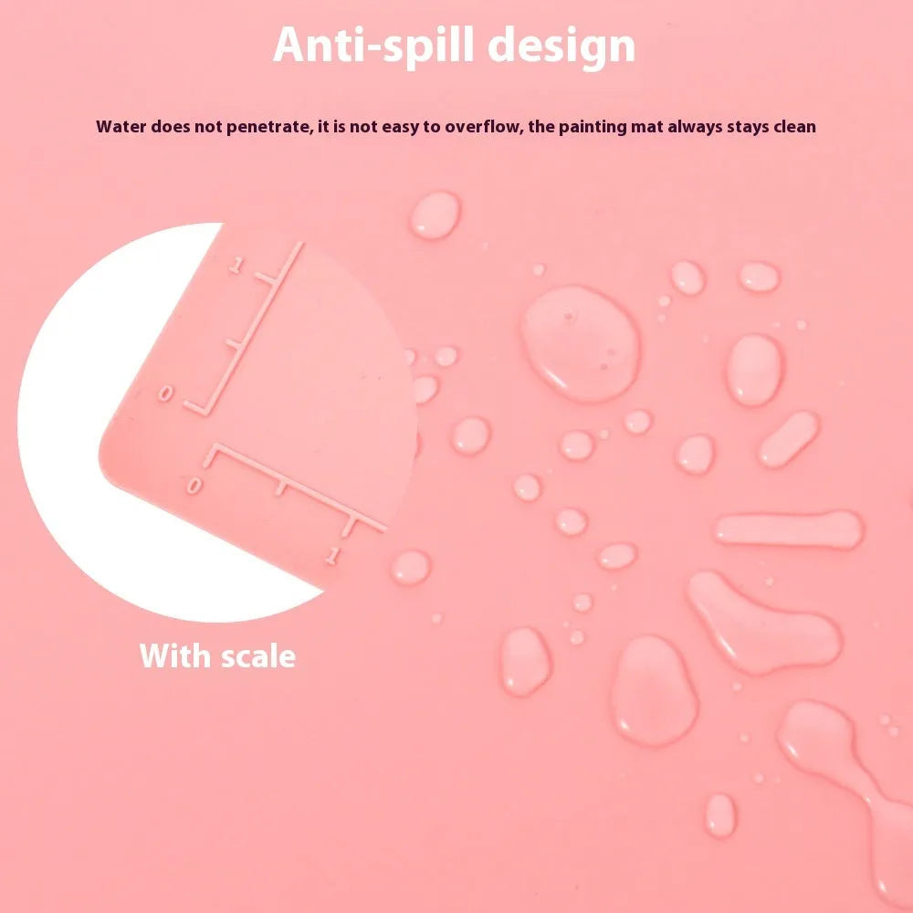 Light blue silicone painting mat with two mixing bowls, measuring 50cm by 40cm on a wooden table.