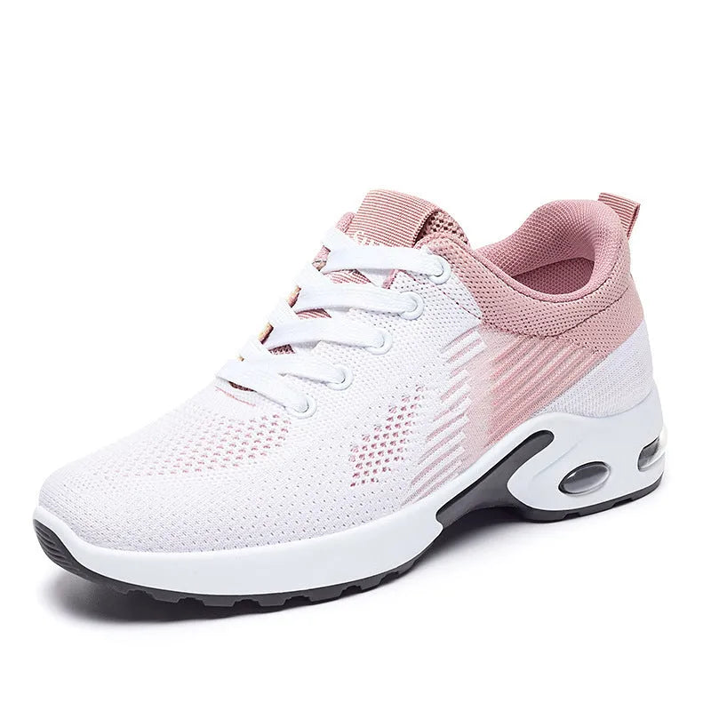 Women's Flyknit casual running shoes in pink with lace-up front and flat PVC sole.