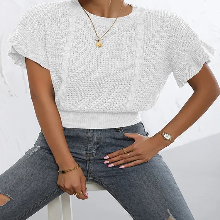 White loose knitted women's pullover sweater with ruffled short sleeves and a textured 3D pattern.