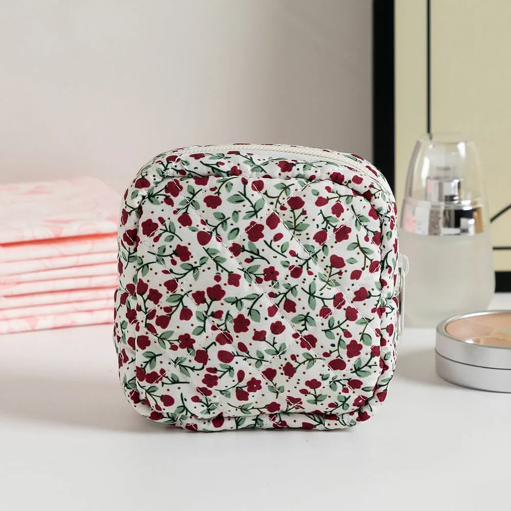 Women's floral patterned polyester key storage bag with sewing thread detail.