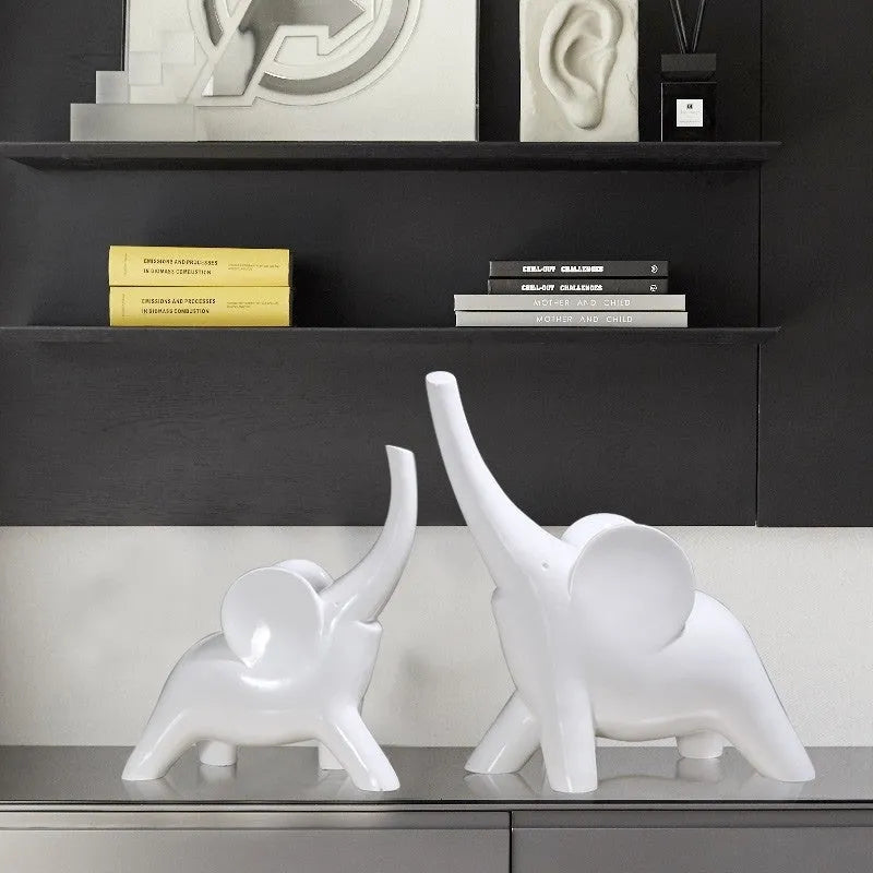 Minimalist rose gold and white resin elephant ornaments on a shelf, showing large and small sizes.
