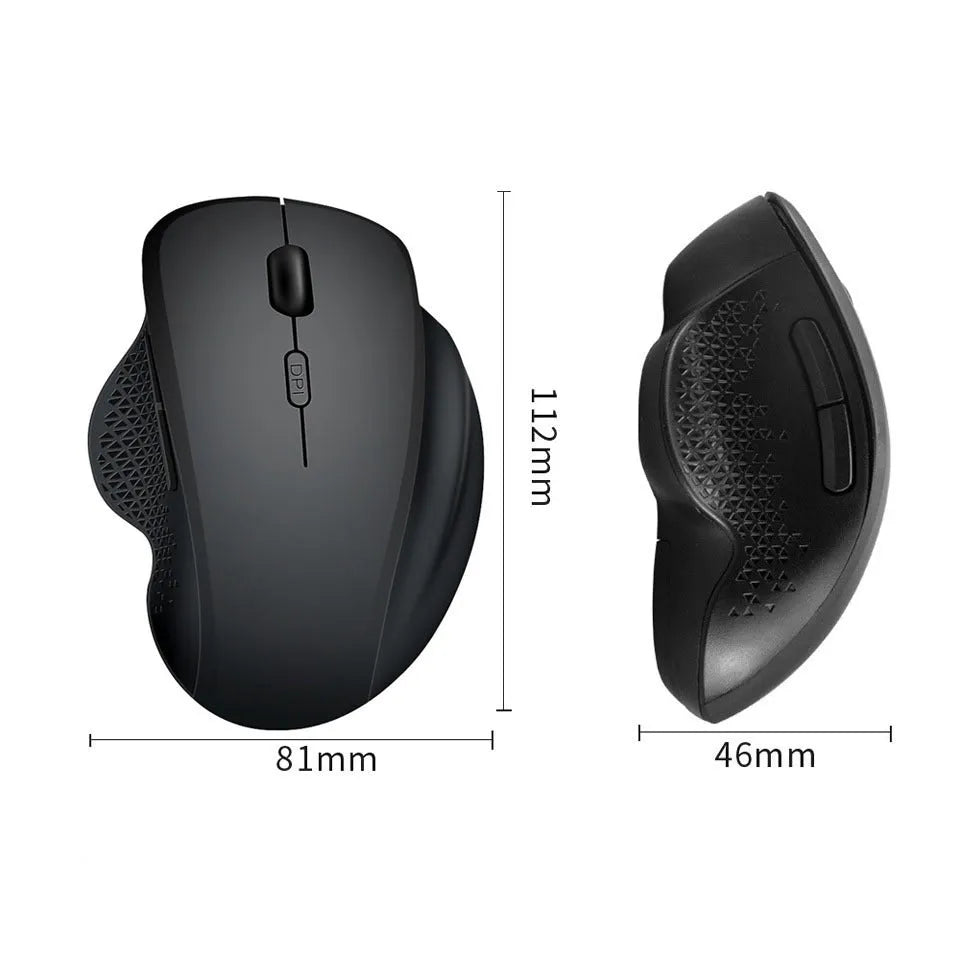 Black wireless laptop mouse with USB-C charging cable on desk next to laptop