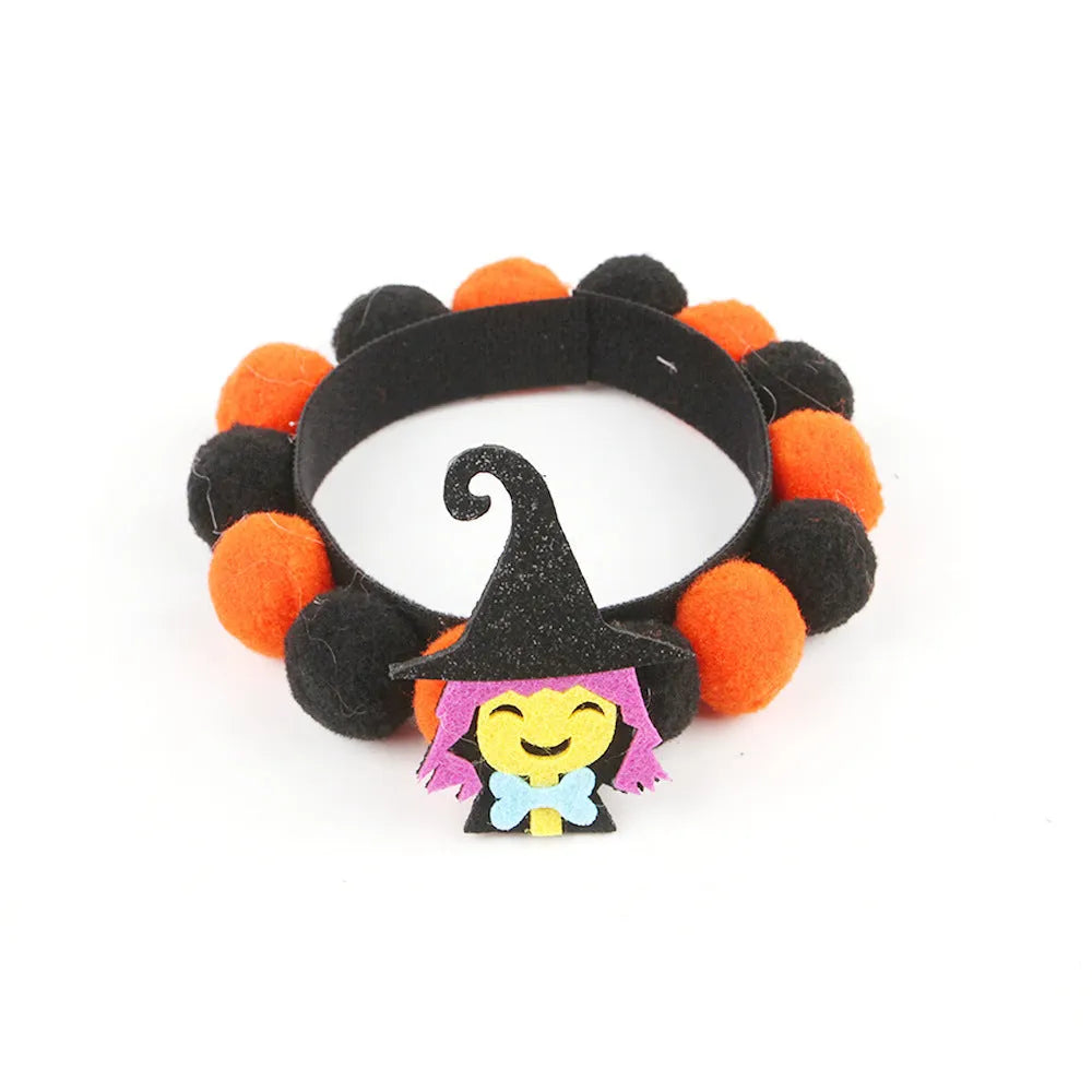 Halloween pet collar with soft fur ball pumpkin accessory in orange, sized on a dog's neck.