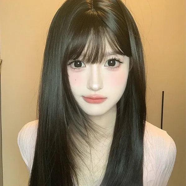 Dark brown long straight synthetic wig with a full fringe on a wig head.