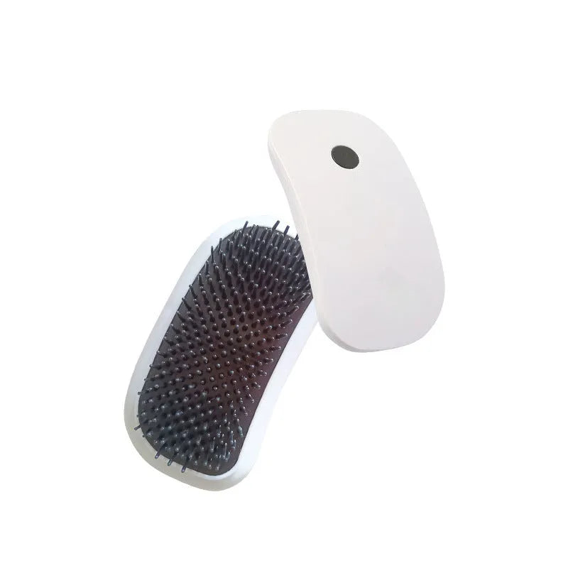 Light pink handheld electric vibration brush for grooming cats and dogs on a white background.