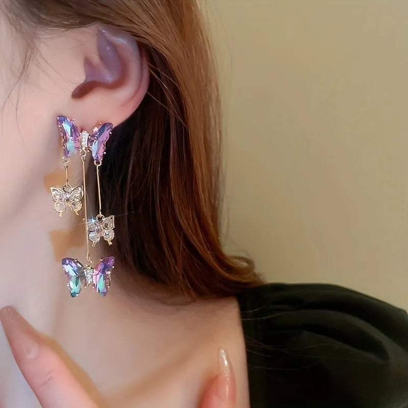 Silver electroplated butterfly tassel earrings with blue-purple crystal flowers on alloy base