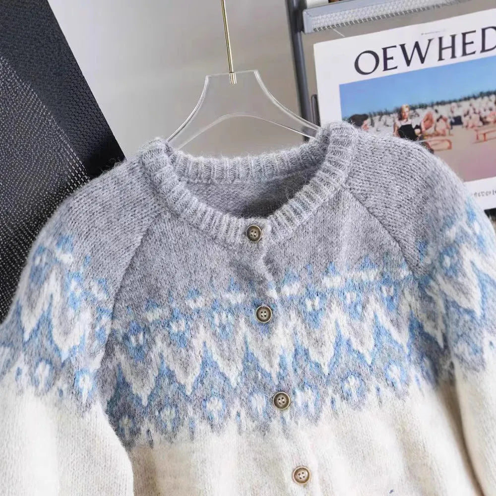 Women's thick jacquard knit sweater coat in a loose fit, shown in milky white colour with long sleeves.