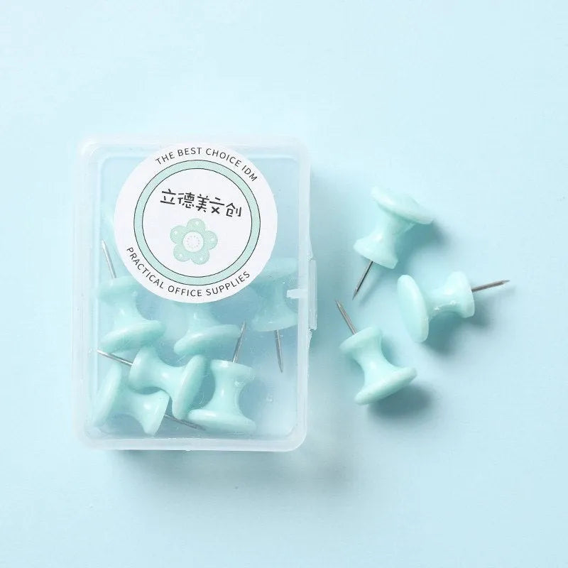 Plastic push pins in mint green, lavender, and pink, showing large and small sizes in a small box.