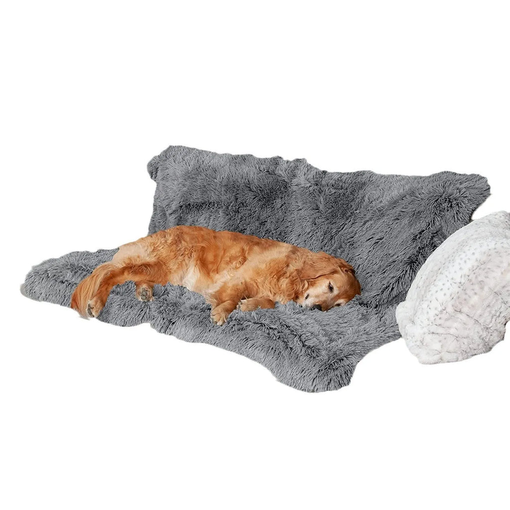 Plush waterproof dog cushion in dark grey, shown in a large size on a wooden floor.