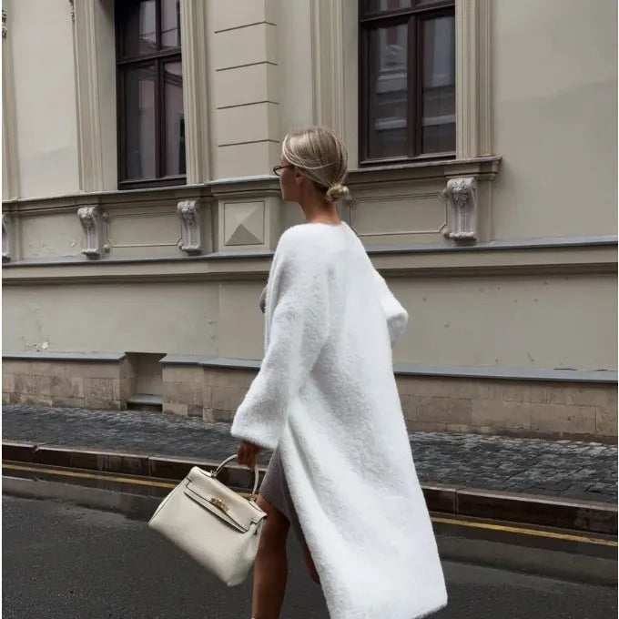 White loose-fit longline cardigan jacket with long sleeves, made of thick knitted polyester fabric.