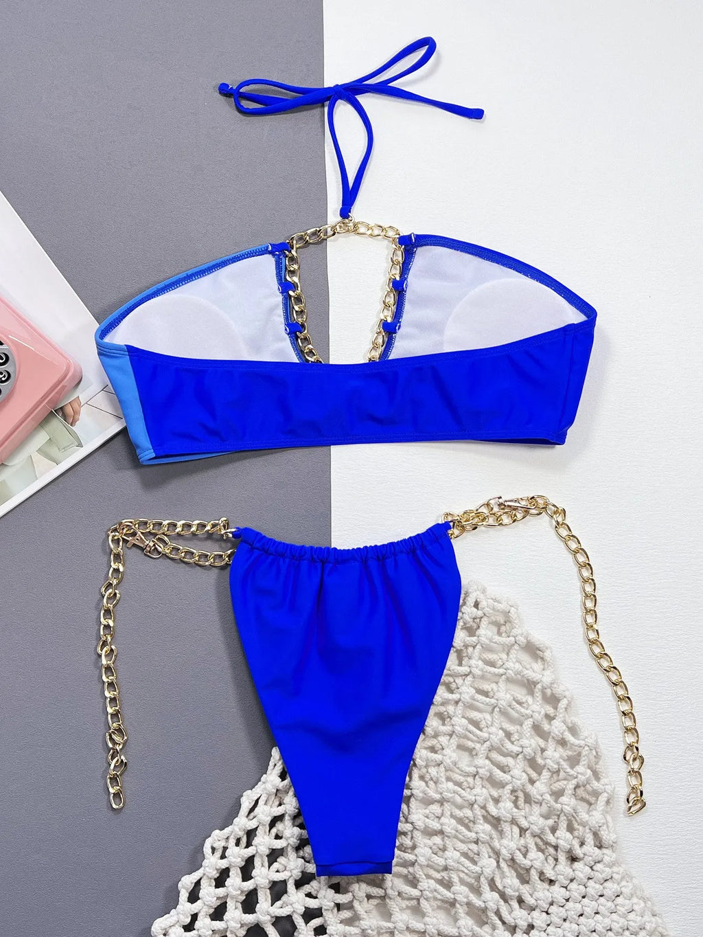 Solid blue women's nylon bikini swimsuit set on a hanger.