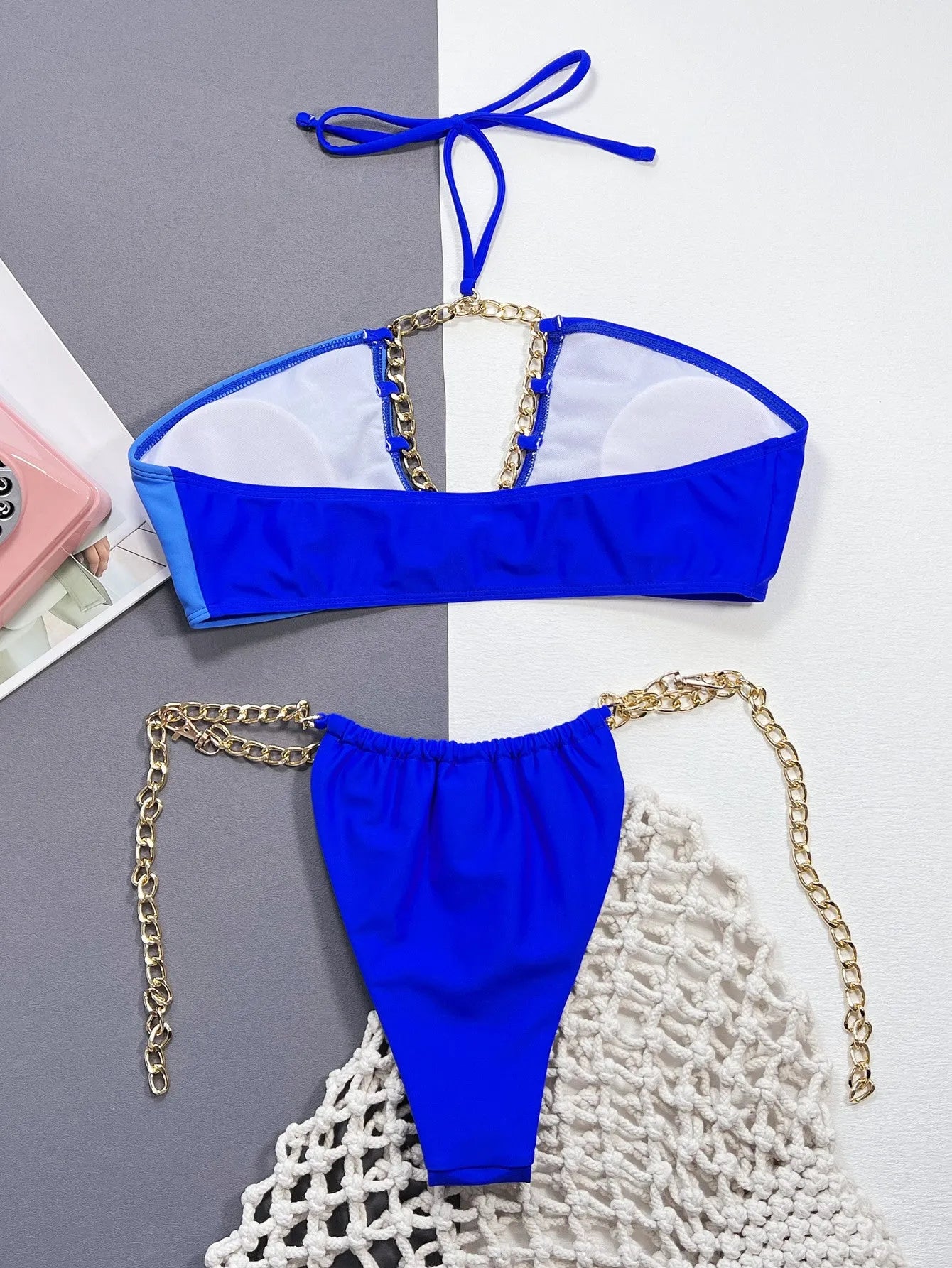 Solid blue women's nylon bikini swimsuit set on a hanger.