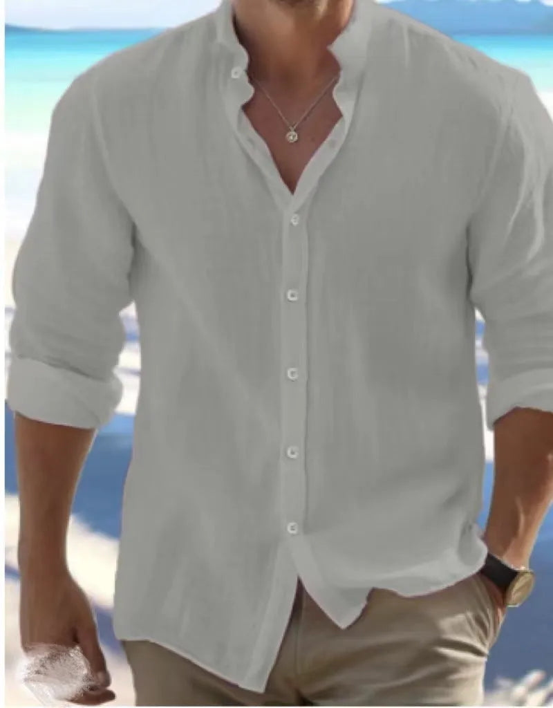 Men's long-staple cotton pullover shirt in light blue with collage stitching detail, laid flat.