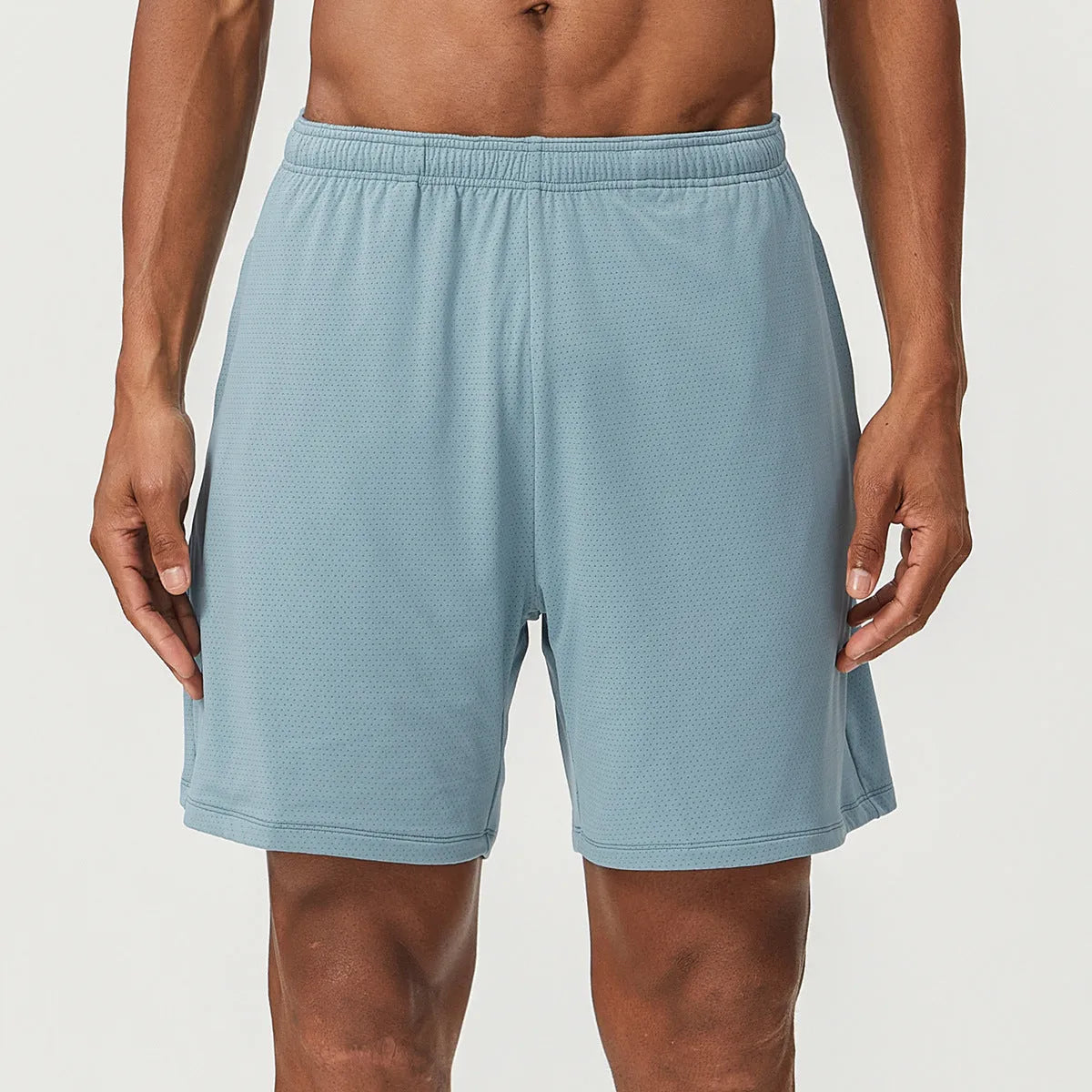 Men's double-layer quick-drying running shorts in brick red colour on a mid-waist model.