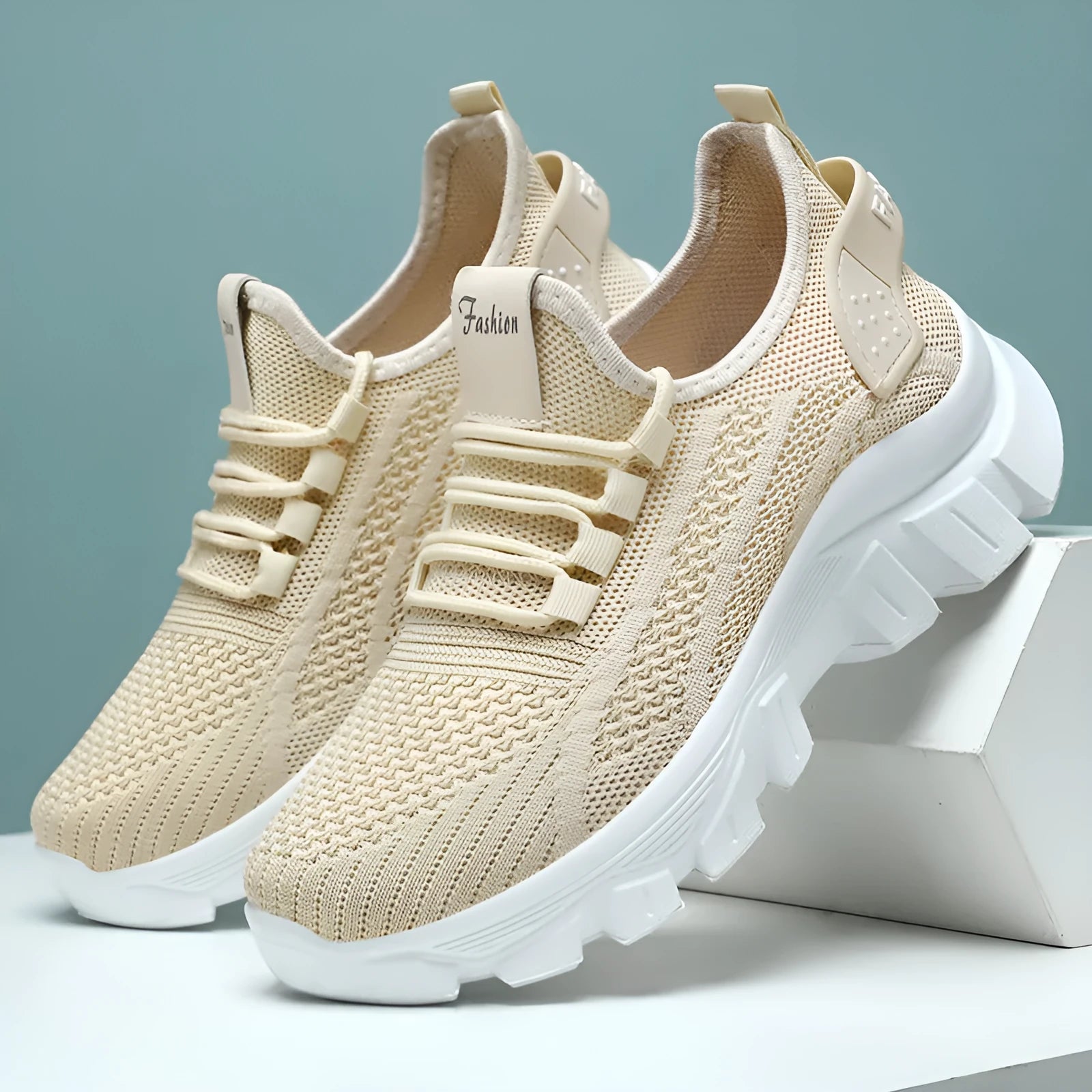 Women's white flyknit casual sneakers with thick PVC sole and round toe, showing lace-up front.