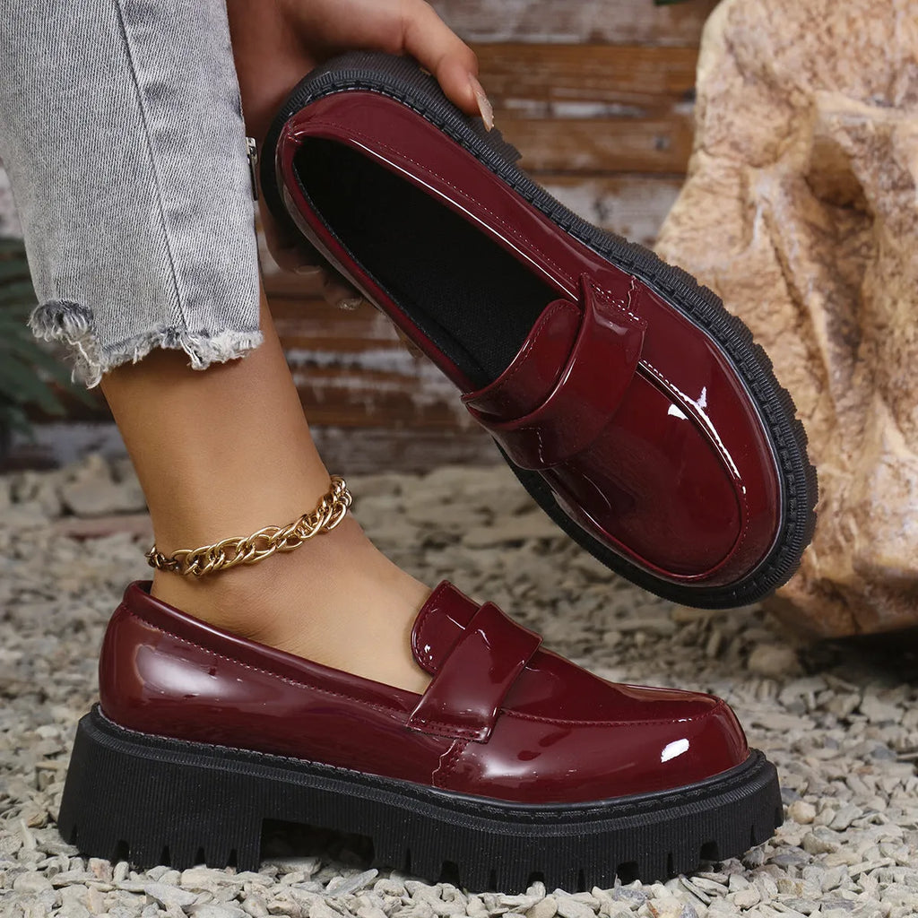 Plus size women's black slip-on loafers with a chunky mid-heel and thick rubber sole.