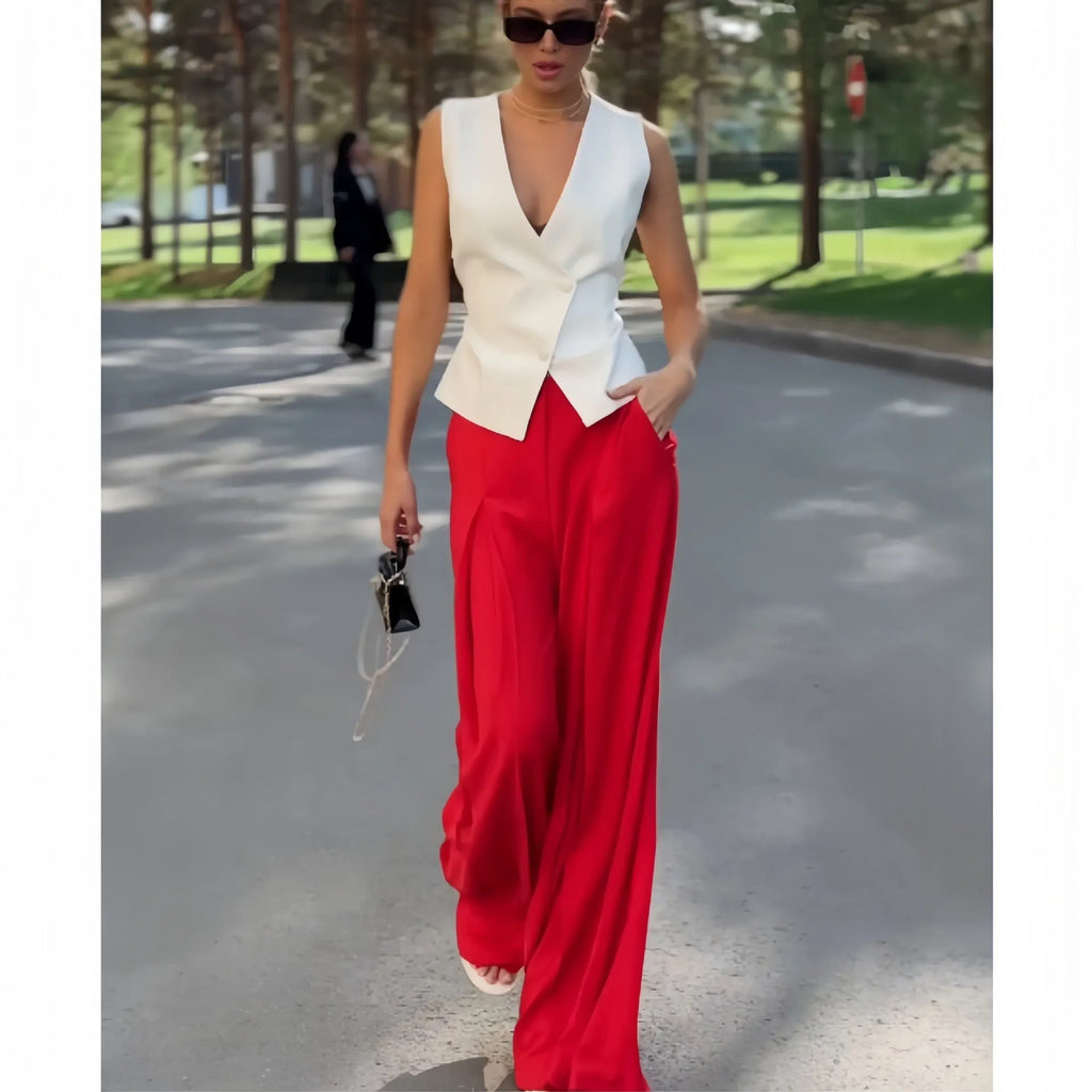 Beige women's two-piece set with deep V-neck sleeveless top and high-waist wide leg trousers