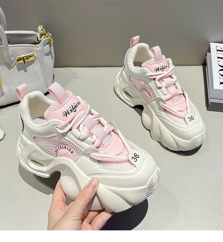 Women's beige casual sneakers with cross shoulder straps and a thick sole.