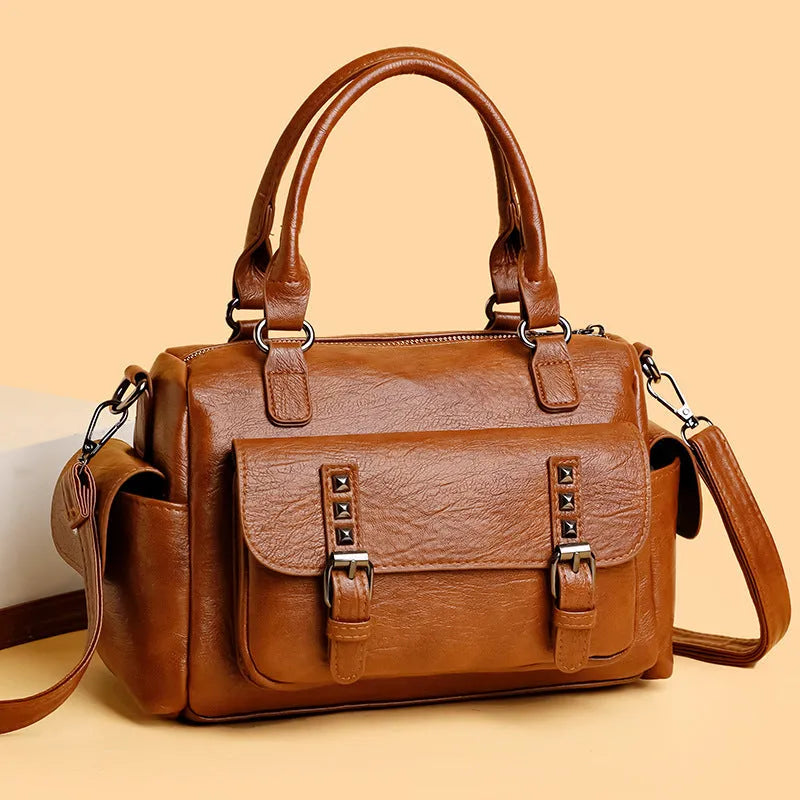Vintage messenger bag in horizontal square shape showing stitching details and shoulder strap
