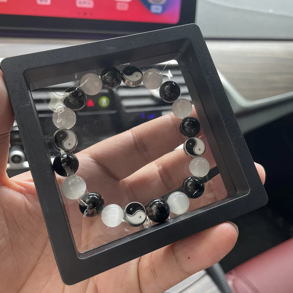 Close-up of a 10mm natural opal and black agate beaded Tai Chi bracelet for men and women.