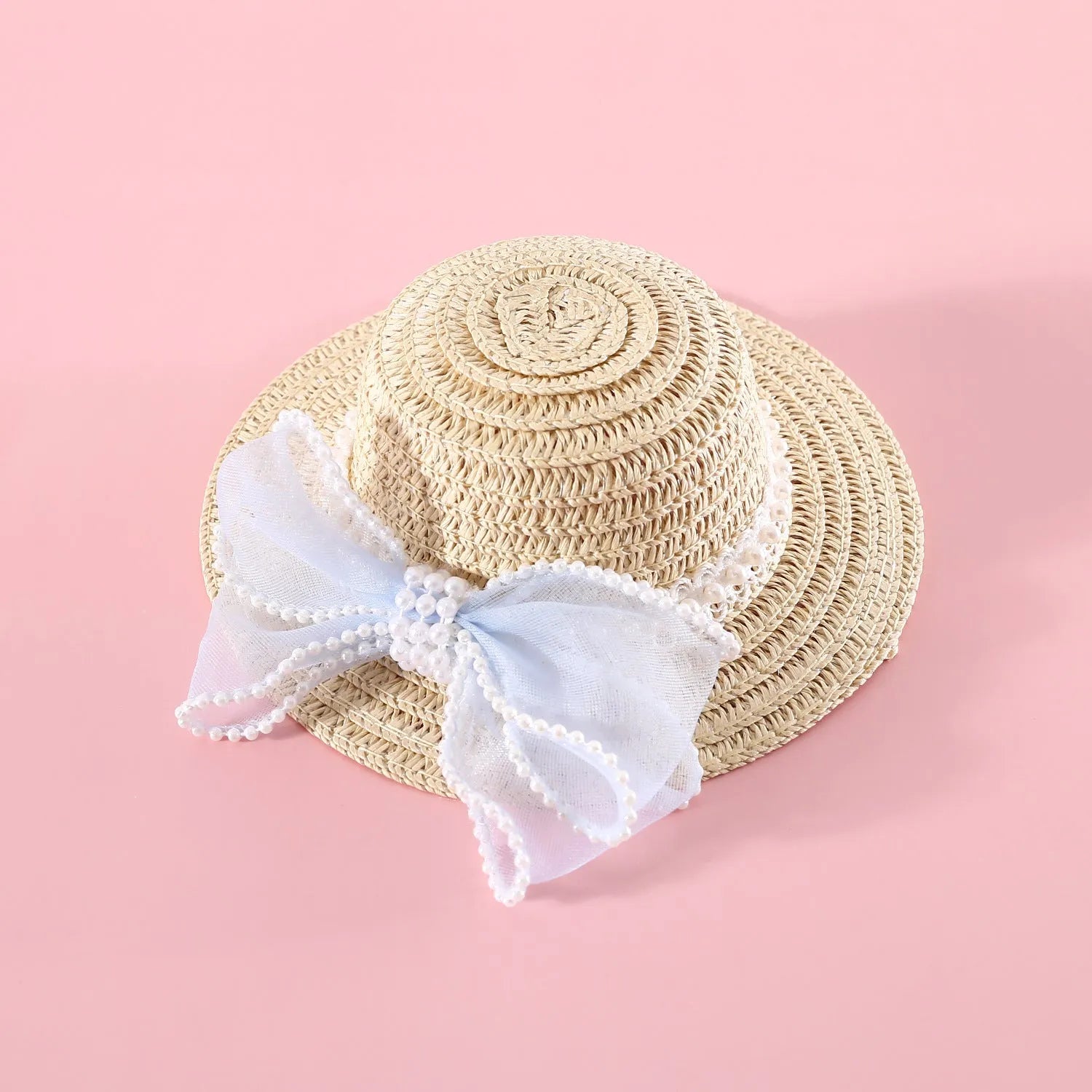 A woven Lafite leaf straw hat for a cat, decorated with a pearl butterfly bow, shown in pink, purple, blue, and white colour options.