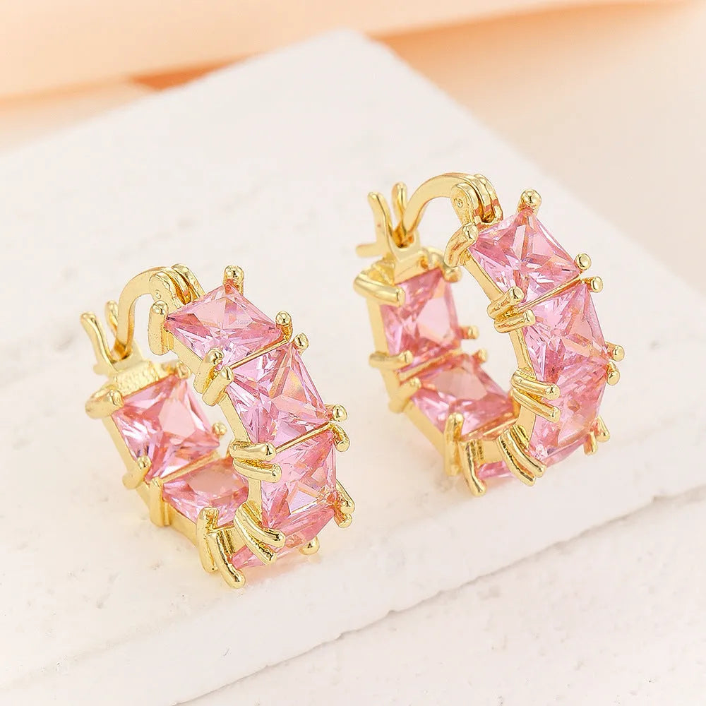 Geometric U-shaped gold earrings with black zircon crystal stones and round decorative elements