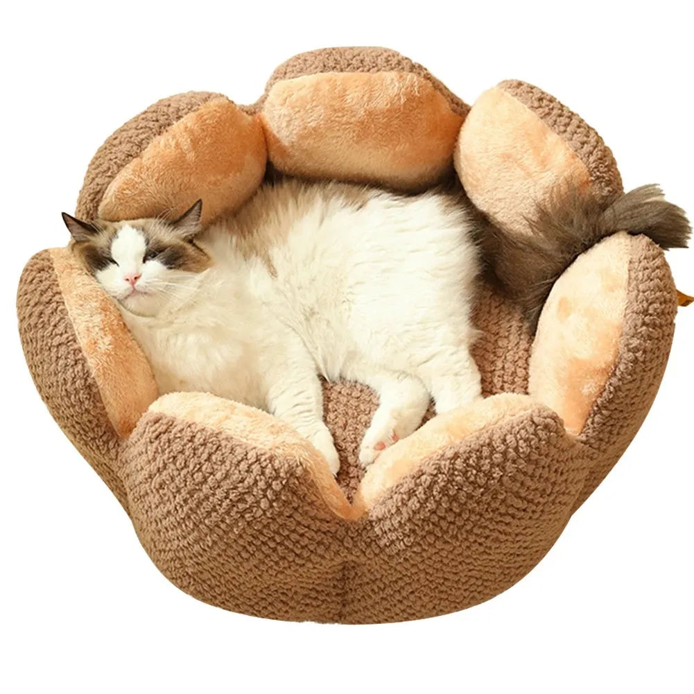 Green cactus petal shaped plush dog bed with a non-slip bottom on a wooden floor.