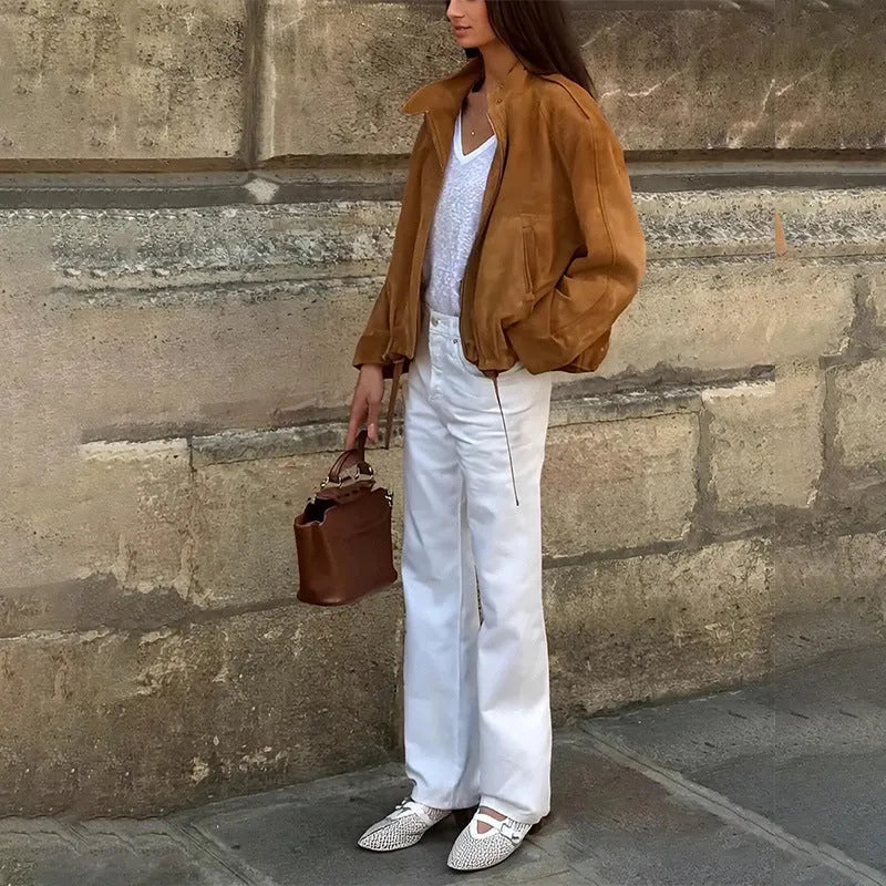 Man wearing a solid colour loose-fit retro style long sleeve polyester jacket.