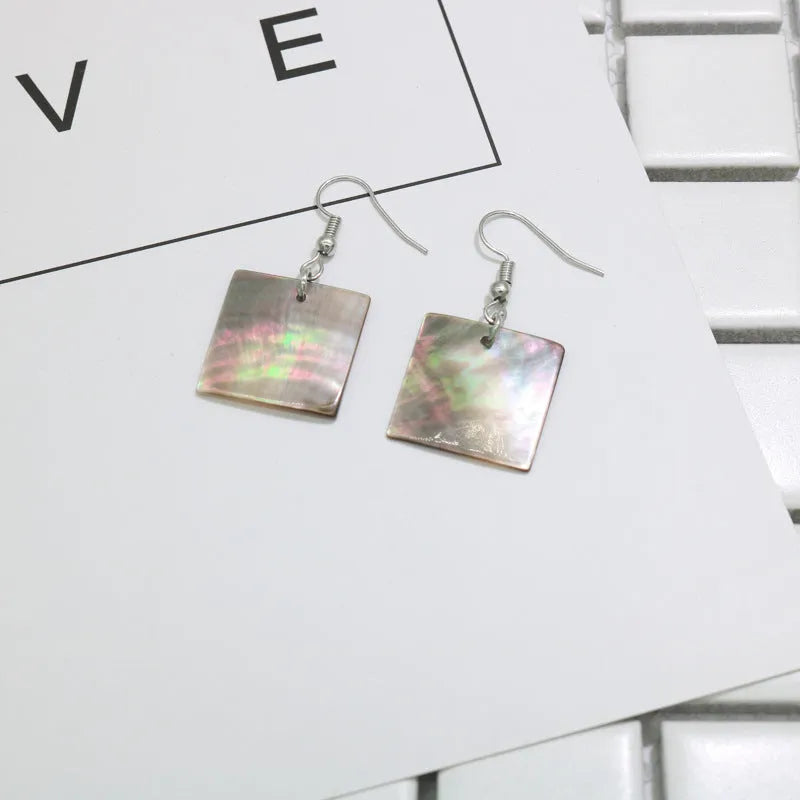 Women's geometric shell earrings with rectangular or square panther designs in natural colours