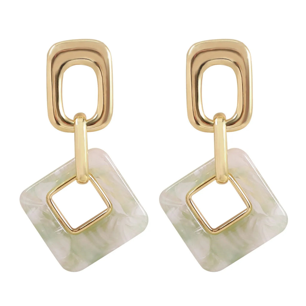 Pair of hollow geometric square earrings with chamfered pattern in silver or black electroplated finish.