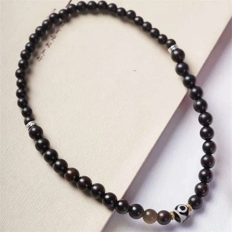 Solid ebony wood bracelet with 8mm Tibetan beads showing two-circle pattern