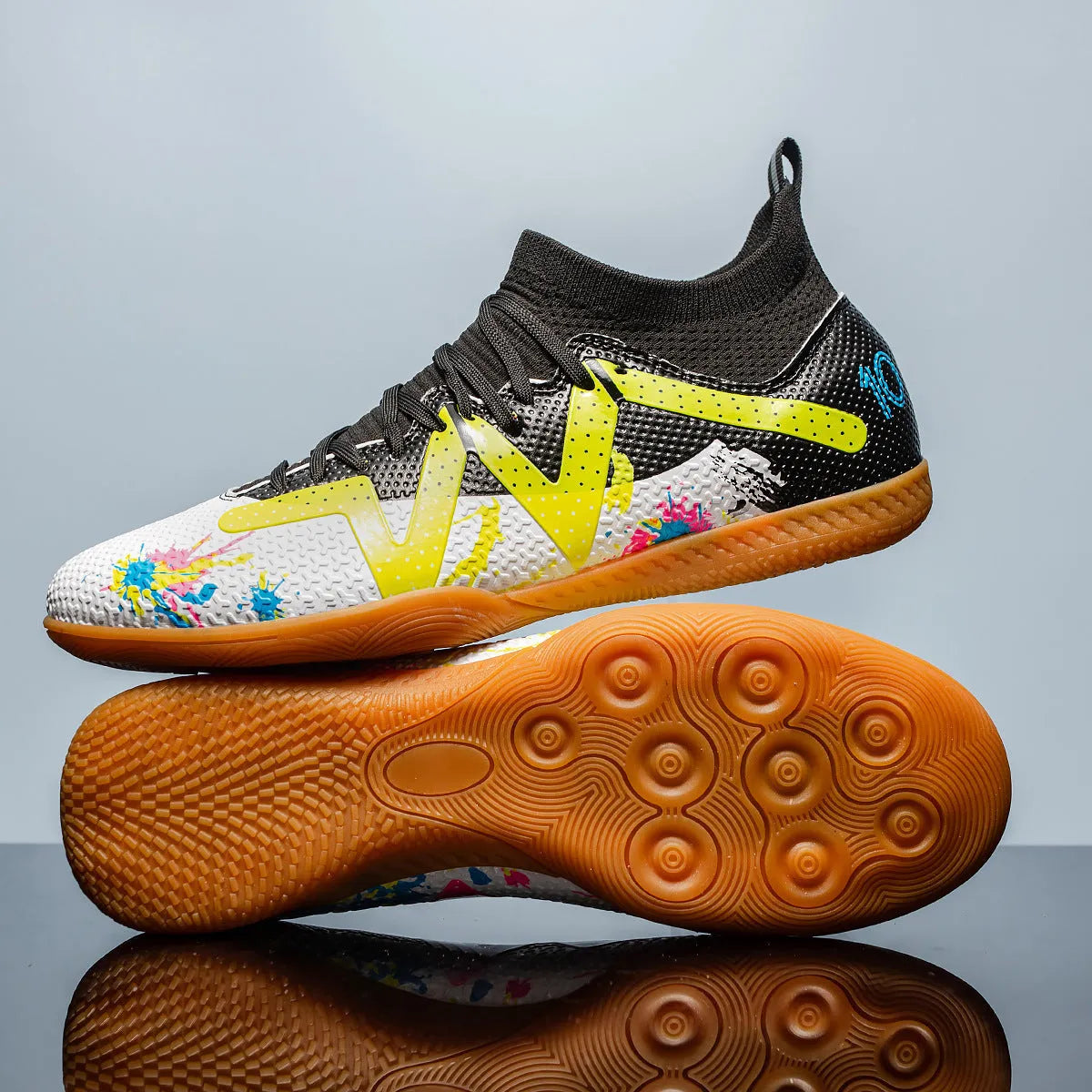Adult low-top football boots with PVC upper and replaceable studs in black and yellow colourway