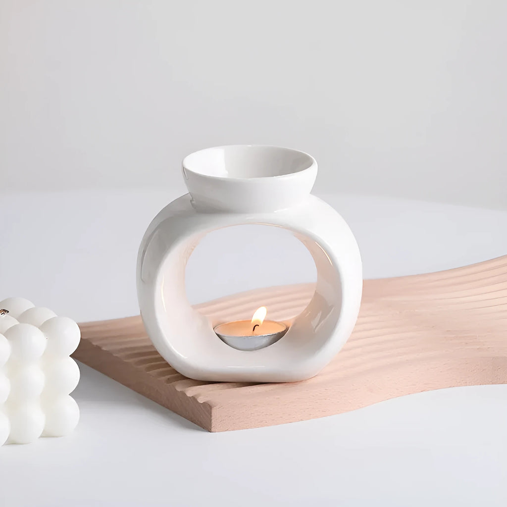White Nordic minimalist ceramic aromatherapy stove ornament for indoor fragrance diffusion.