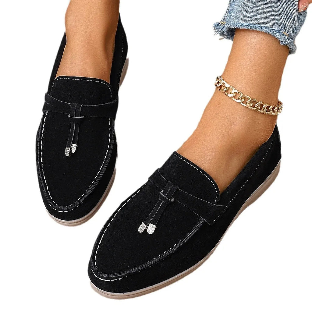 Casual slip-on loafers with canvas upper, platform rubber sole, and round toe in black colour