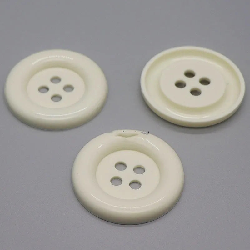 Oversized round plastic sewing buttons in multiple colours with four holes