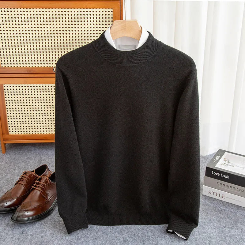 Man wearing a half-collar loose wool sweater in a textured rough yarn knit.
