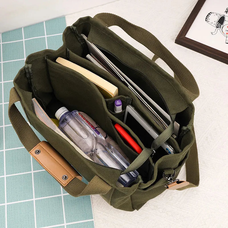 Canvas tote bag showing multiple internal compartments and both sides zipper openings in horizontal square shape